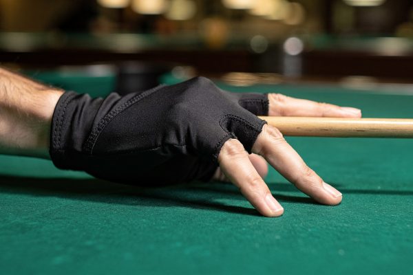 Three-finger billiard glove on hand in proper bridge position holding pool cue