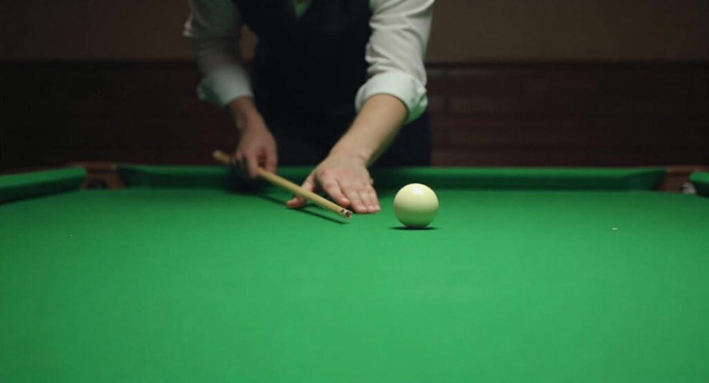 Pool player testing cue straightness